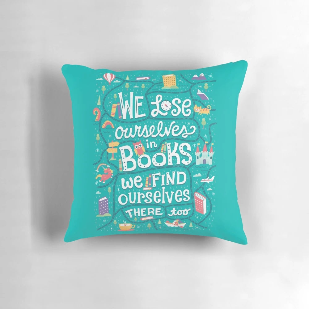 A soft, plush pillow with a whimsical design featuring books, a unicorn, and a castle, perfect for book lovers.