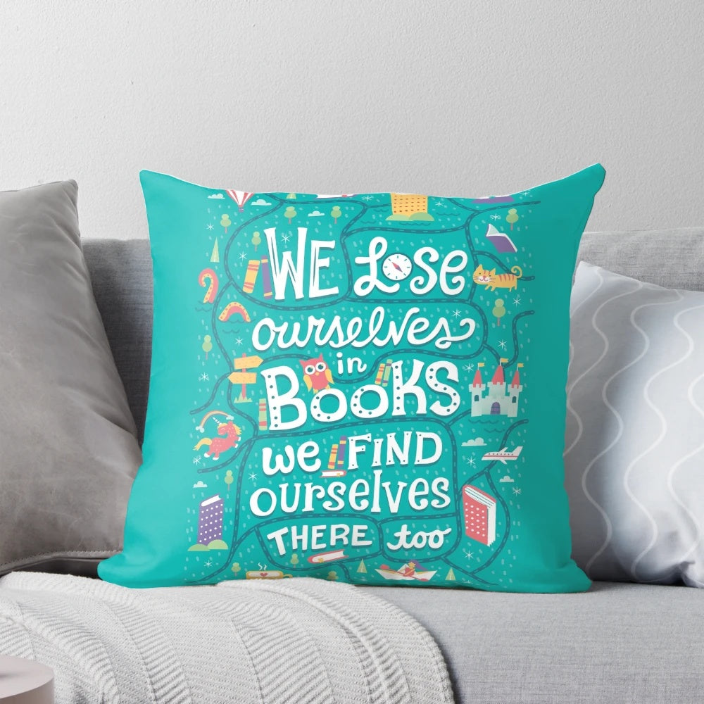 A soft, plush pillow with a whimsical design featuring books, a unicorn, and a castle, perfect for book lovers.