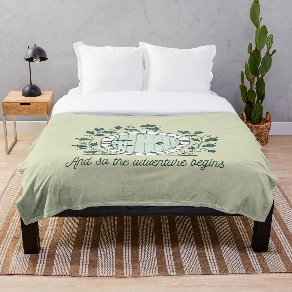 Plush blanket featuring a Bilbo Baggins-inspired design with The Shire and Middle Earth elements