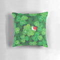 A soft, plush pillow featuring a happy, smiling snail sitting on a 4-leaf clover