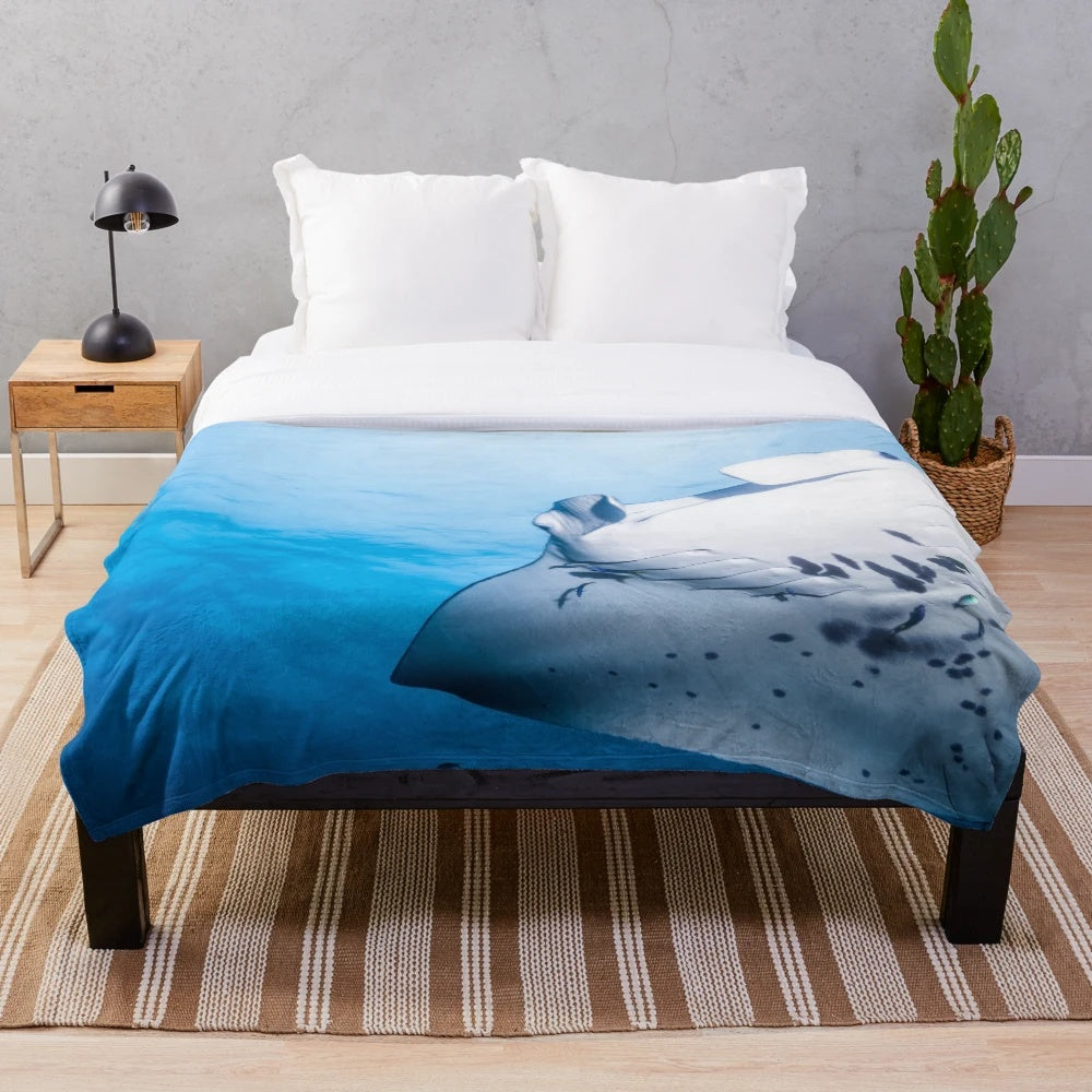 Manta ray swimming in the blue ocean plush blanket