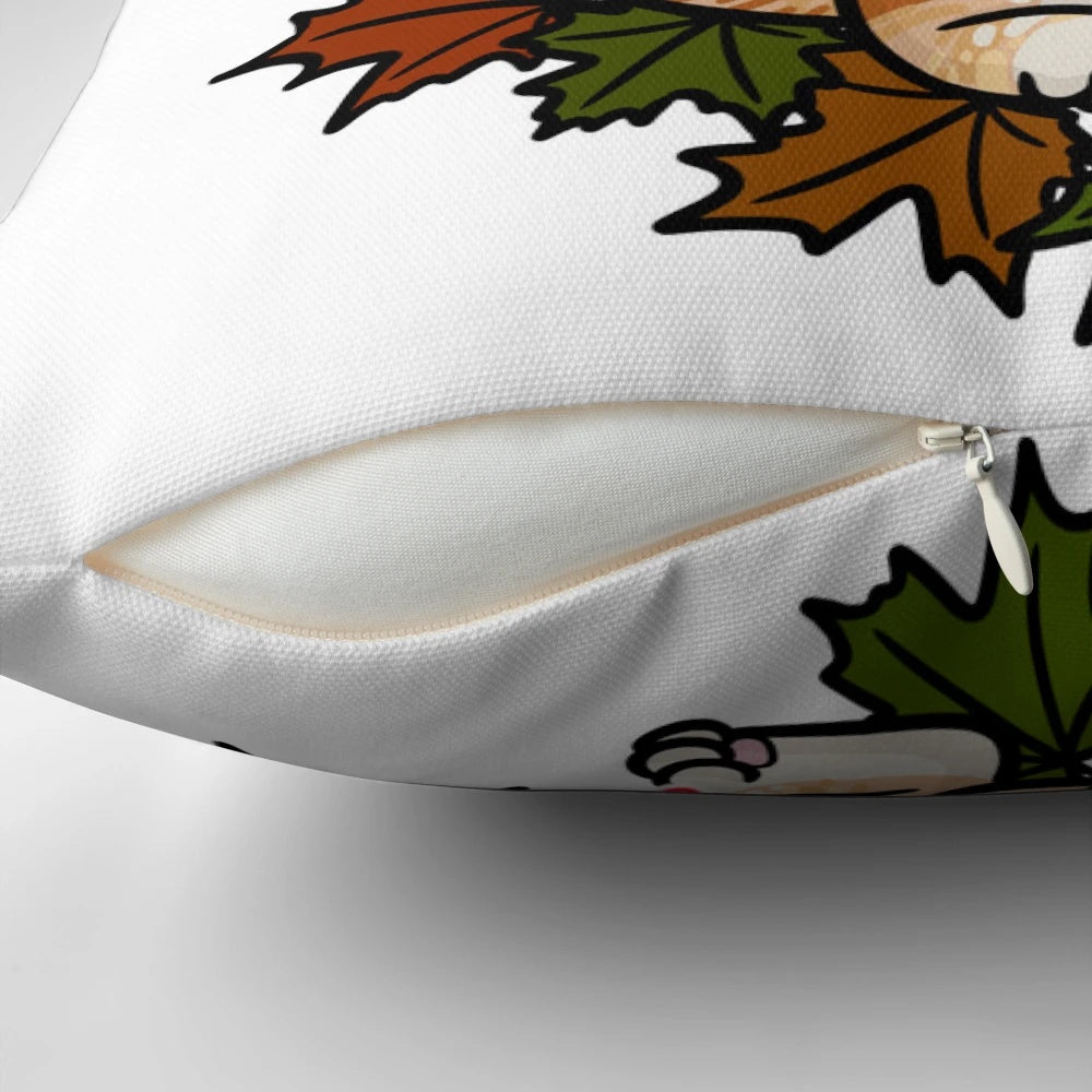 Close-up of an orange tabby cat curled up on a pillow with colorful maple leaves, perfect for fall decor.