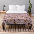 Floral crowned highland cows printed on a mauve plush blanket