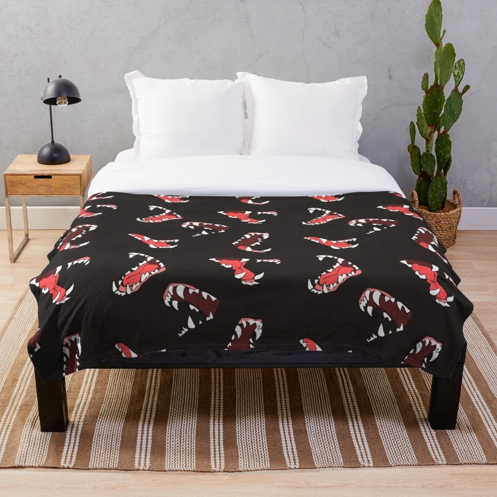 Maws Plush Blanket with a wolf-themed design featuring canine teeth and fur