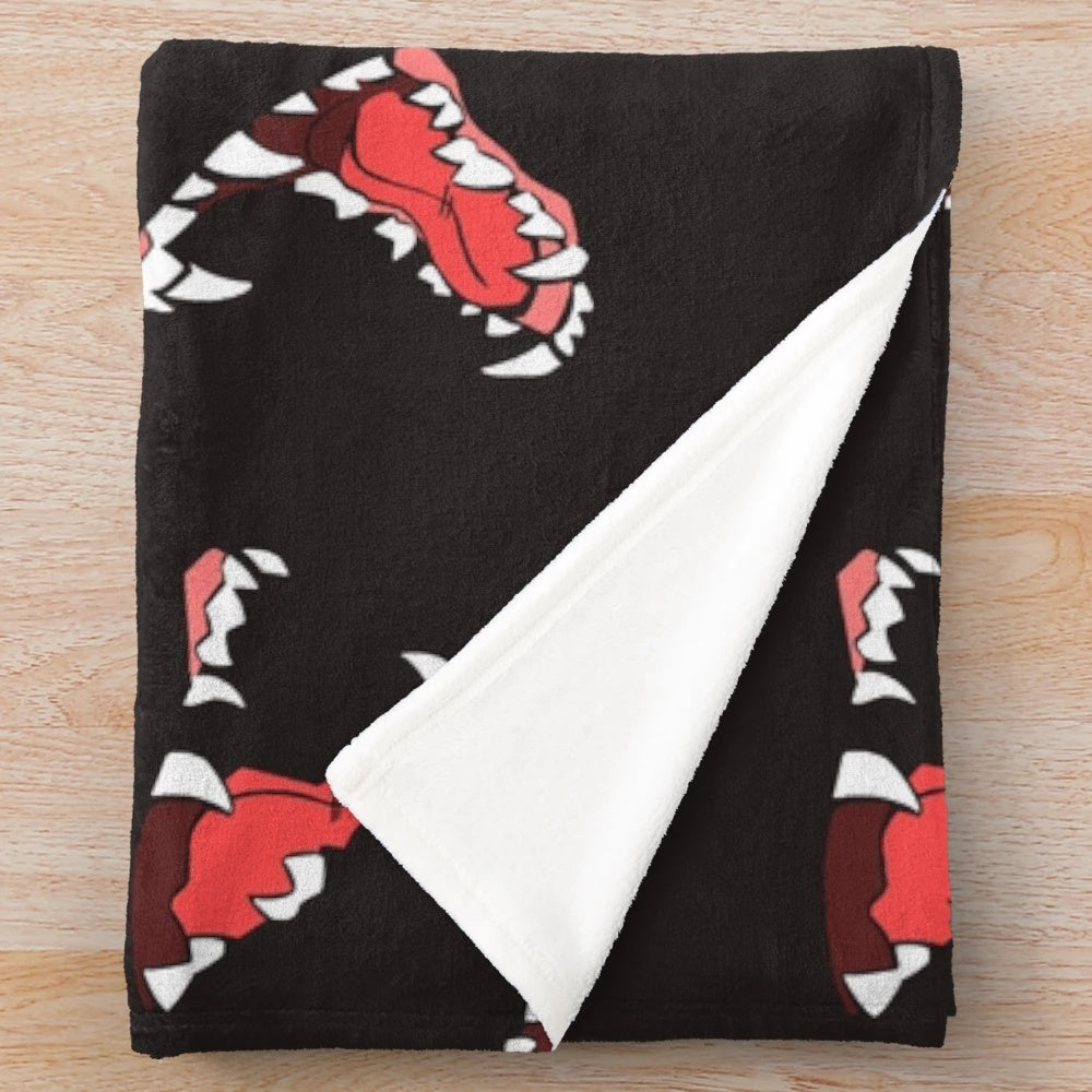 Maws Plush Blanket with a wolf-themed design featuring canine teeth and fur