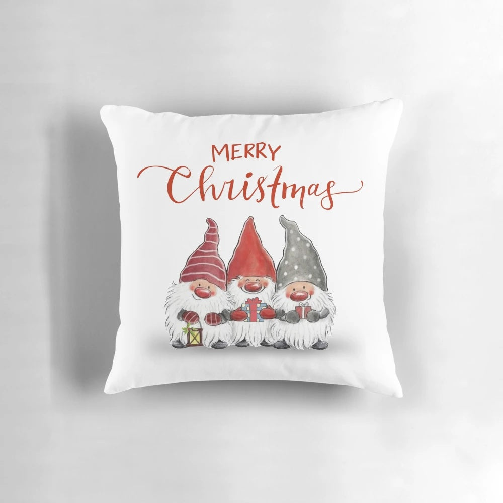 A plush, festive pillow featuring cute cartoon Christmas gnomes in a whimsical design.