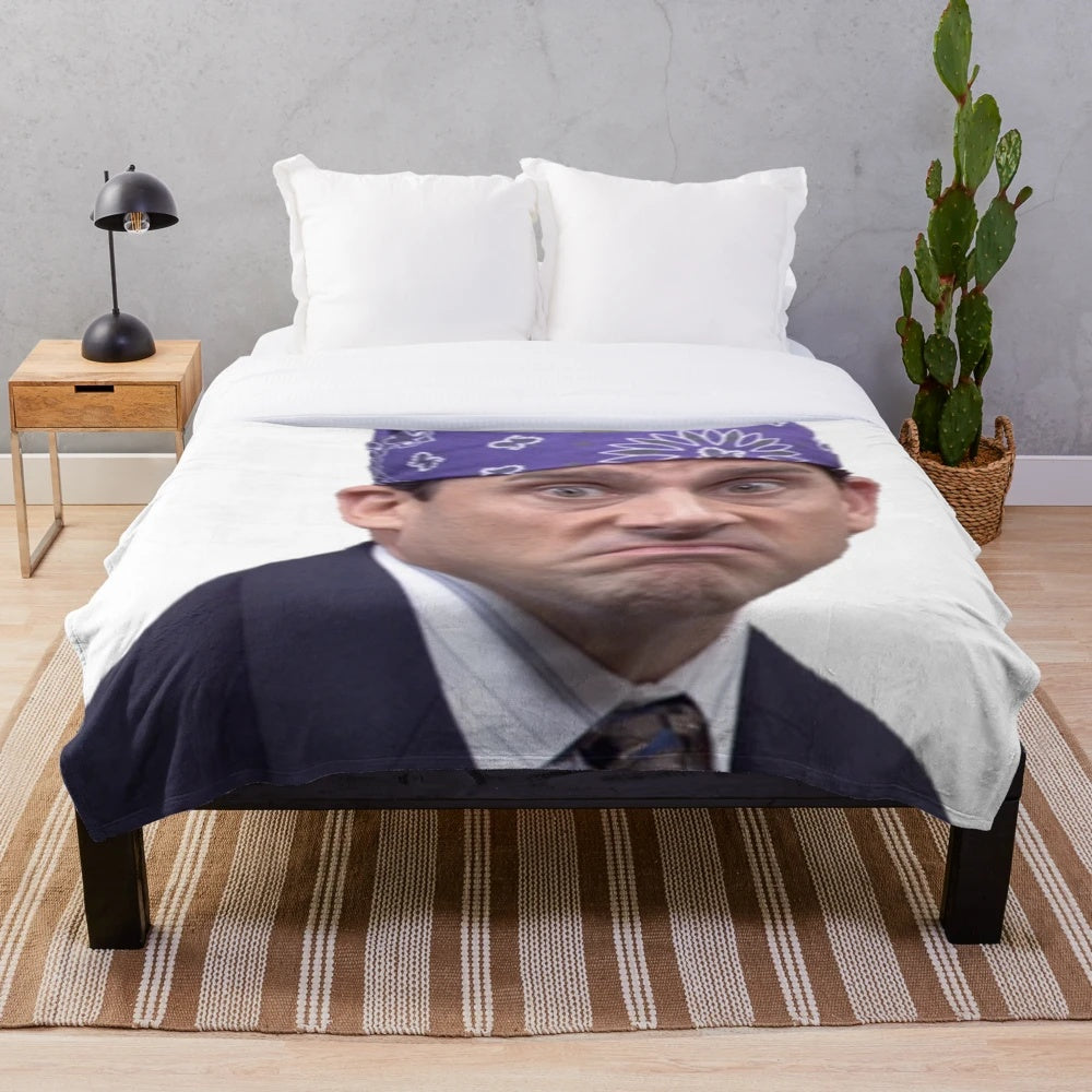 A soft and plush blanket featuring the character Prison Mike from the TV show The Office
