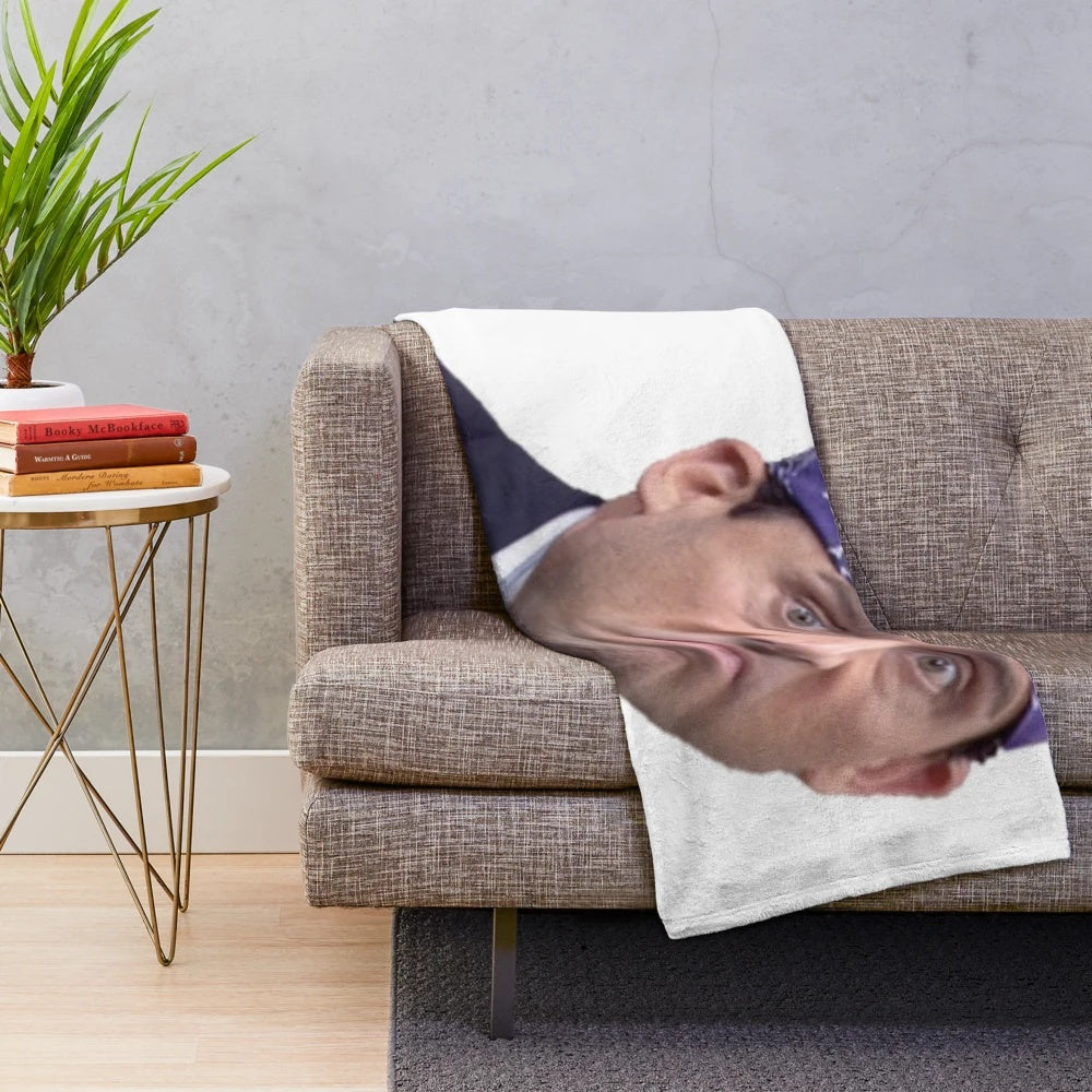 A soft and plush blanket featuring the character Prison Mike from the TV show The Office