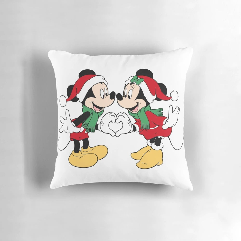 A soft, plush pillow featuring the iconic Disney characters Mickey Mouse and Mini Mouse dressed in Santa outfits.