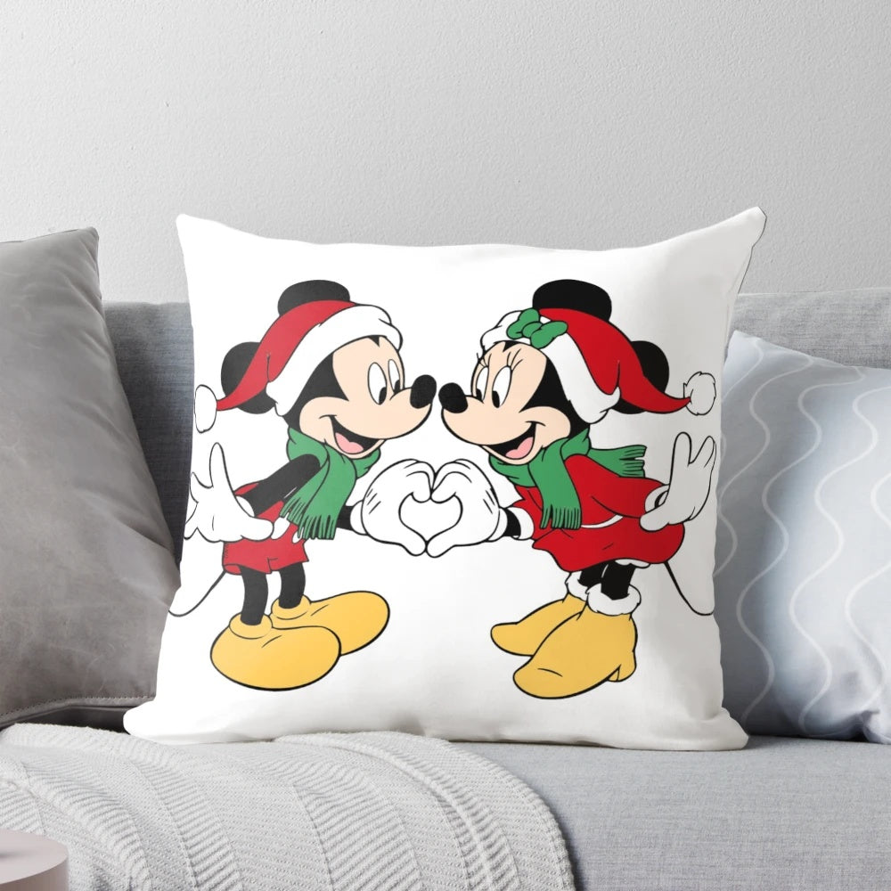 A soft, plush pillow featuring the iconic Disney characters Mickey Mouse and Mini Mouse dressed in Santa outfits.