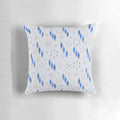 A mid century modern style pillow featuring a winter holiday design with sputnik starbursts, snowflakes, and ornaments.