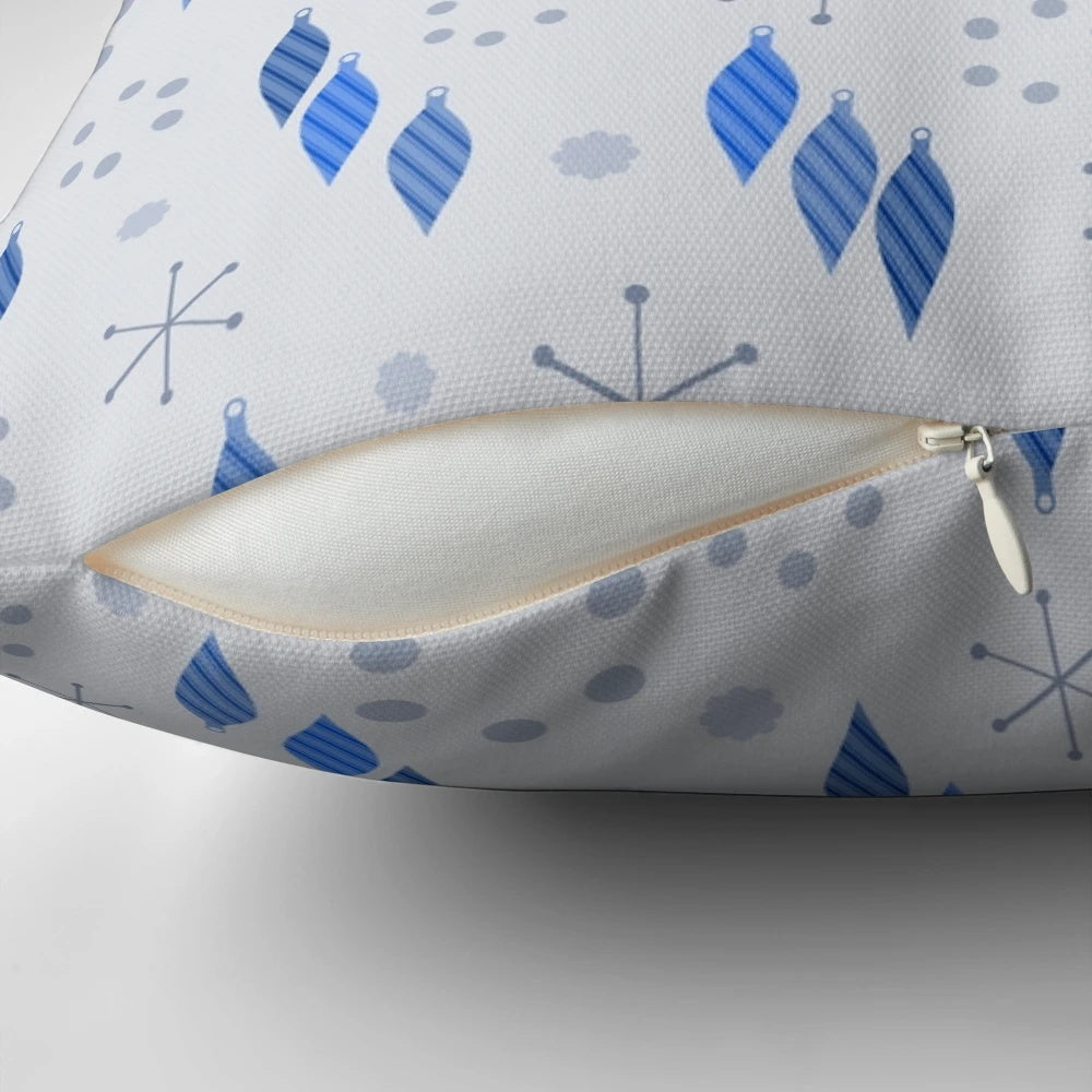 A mid century modern style pillow featuring a winter holiday design with sputnik starbursts, snowflakes, and ornaments.