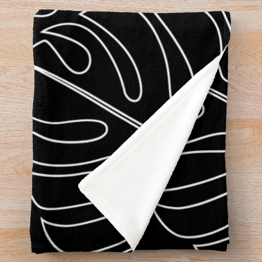 Minimalistic monstera plush blanket with tropical leaf pattern