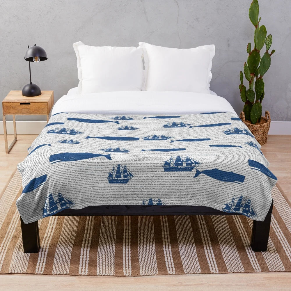 Moby Dick themed plush blanket with whales, ships, and ocean motifs