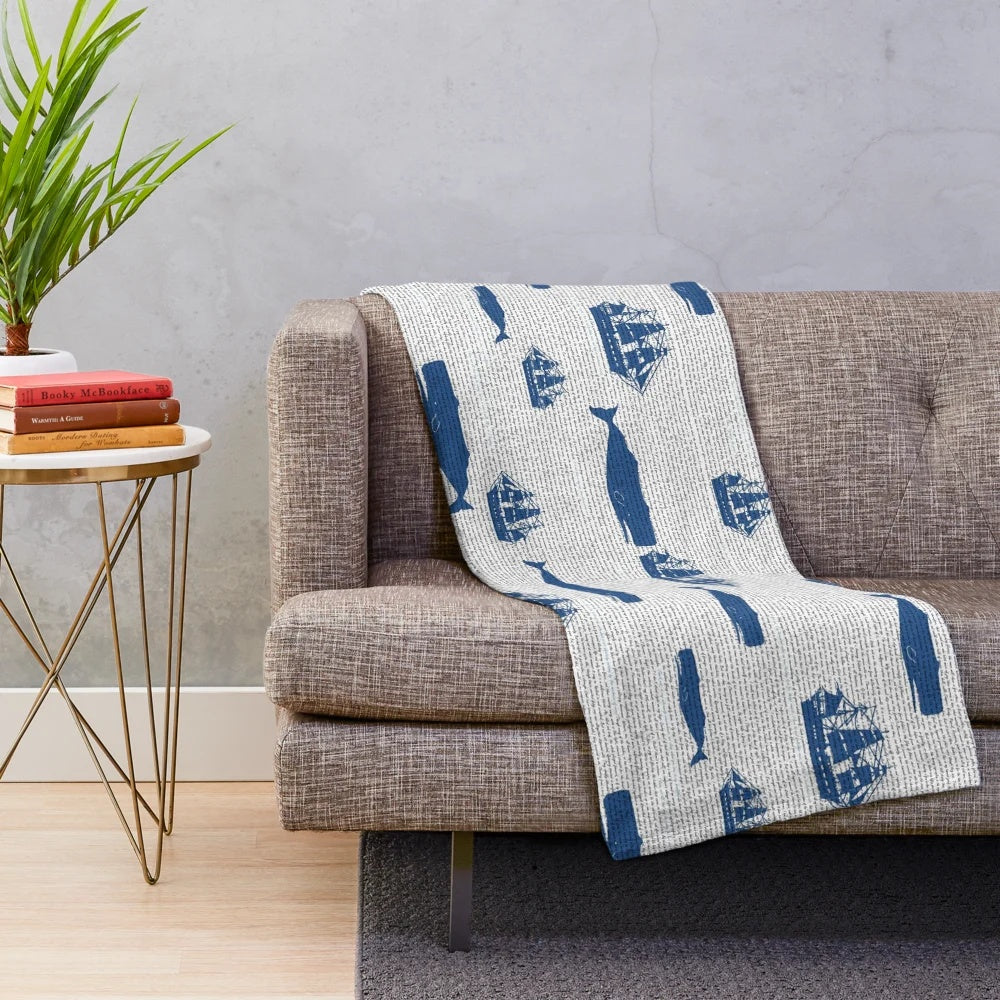 Moby Dick themed plush blanket with whales, ships, and ocean motifs