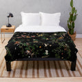 Plush monkey-themed blanket with botanical and tropical print