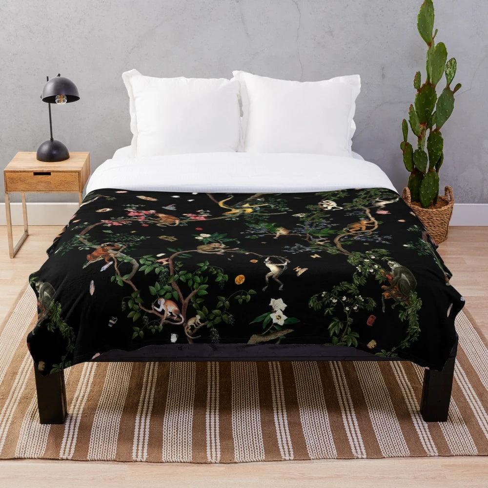 Plush monkey-themed blanket with botanical and tropical print