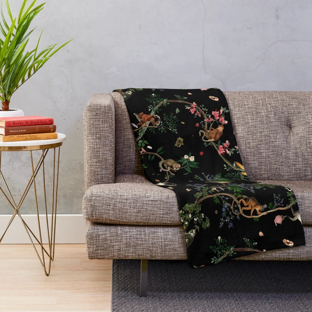 Plush monkey-themed blanket with botanical and tropical print