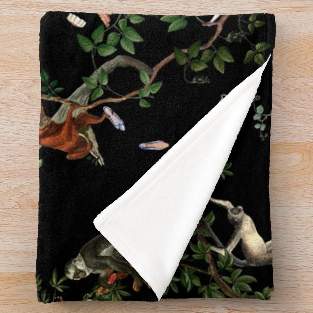 Plush monkey-themed blanket with botanical and tropical print