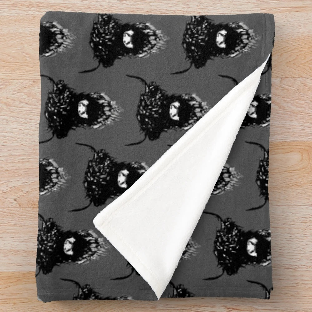Monochrome sketch of a highland cow on a dark grey plush blanket