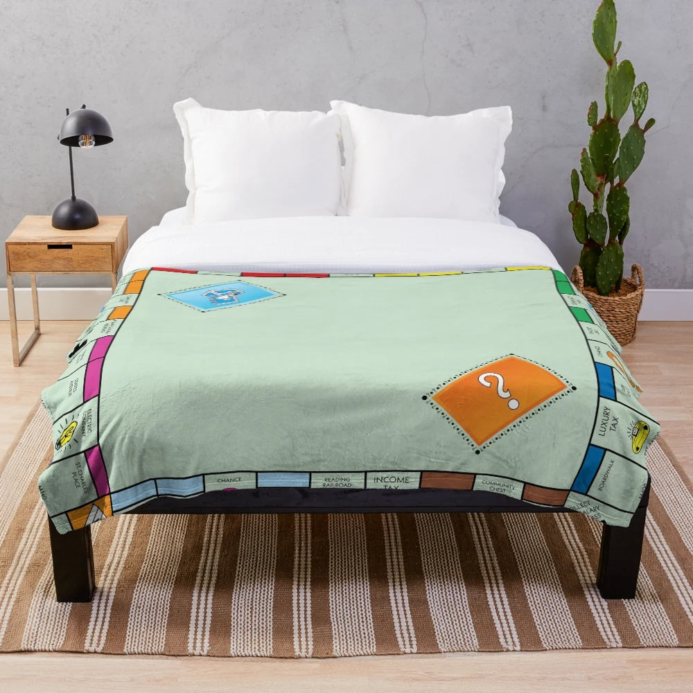 Monopoly-themed plush blanket with classic board game design