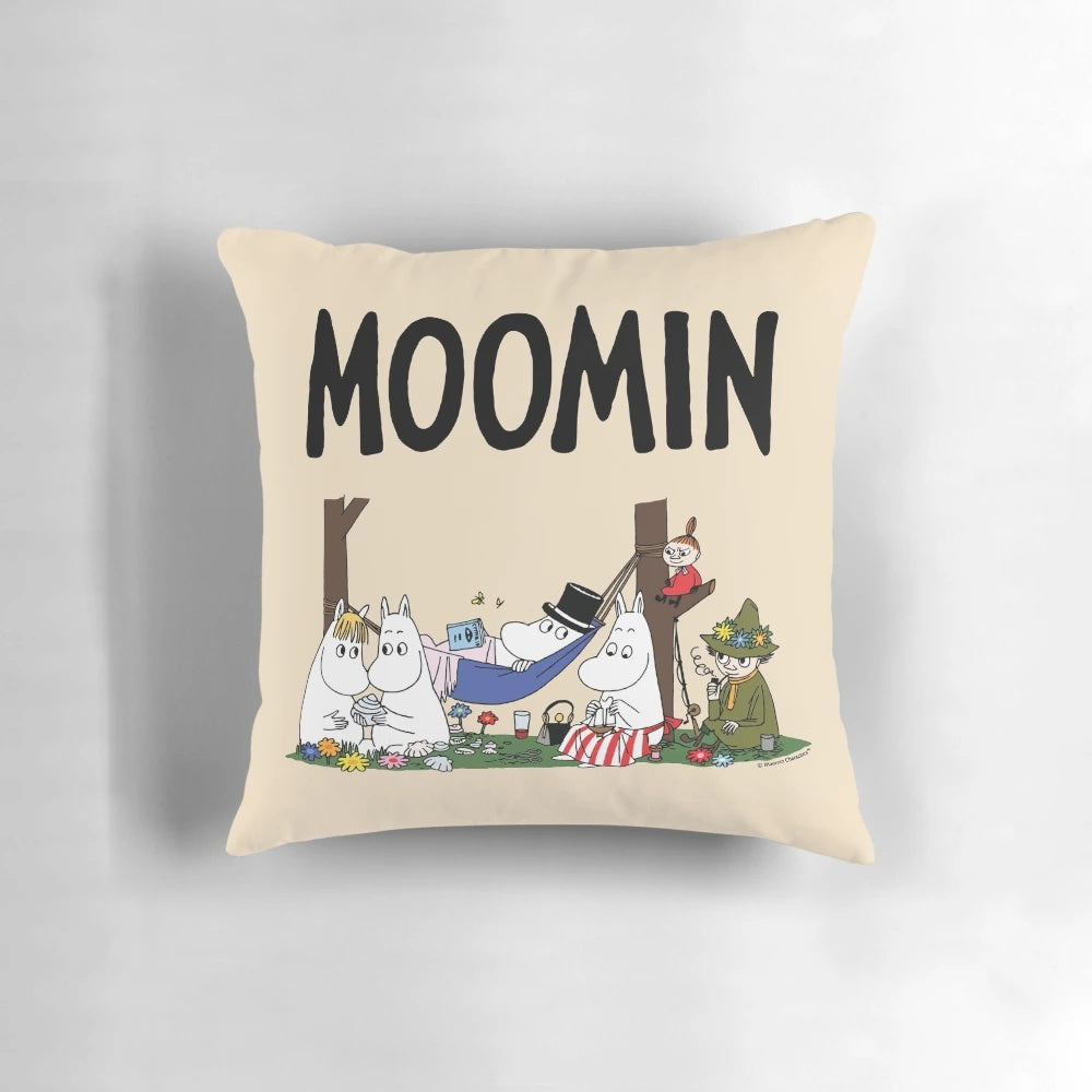 Moomin family characters relaxing on a soft, plush pillow