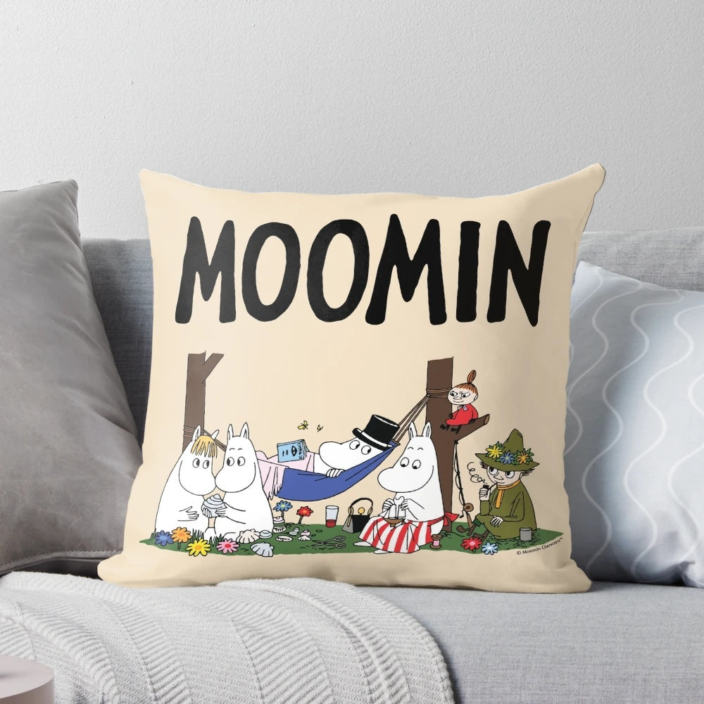 Moomin family characters relaxing on a soft, plush pillow