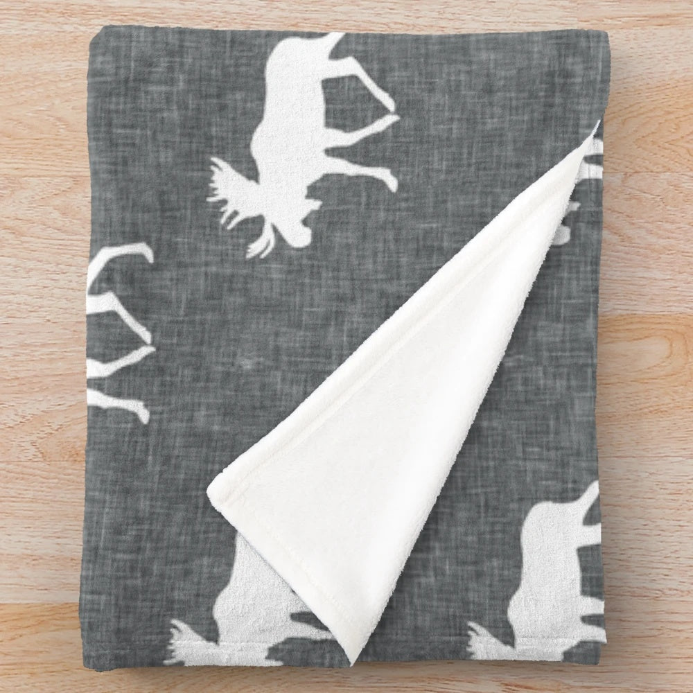 Soft and plush moose-printed grey blanket for a woodland-inspired nursery