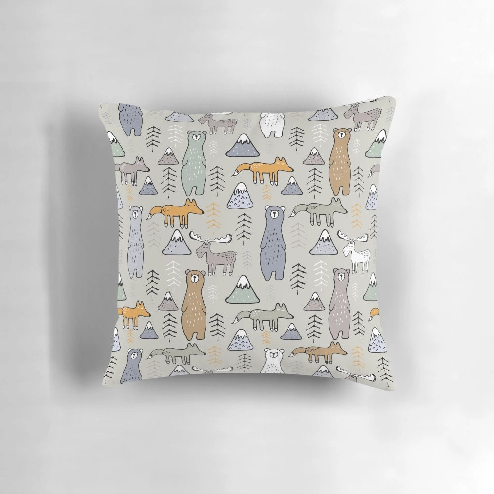 Colorful mountain scene with cute forest animals like bears, moose, and foxes on a plush pillow