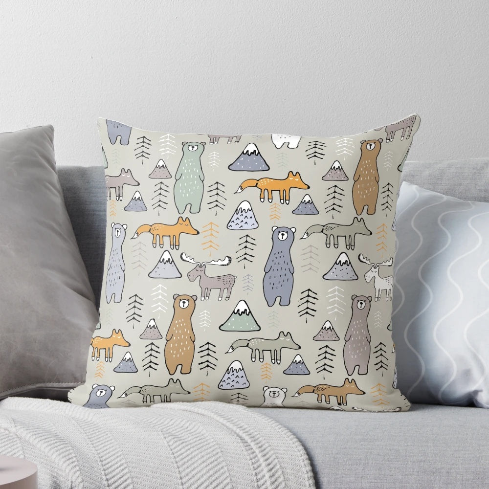 Colorful mountain scene with cute forest animals like bears, moose, and foxes on a plush pillow