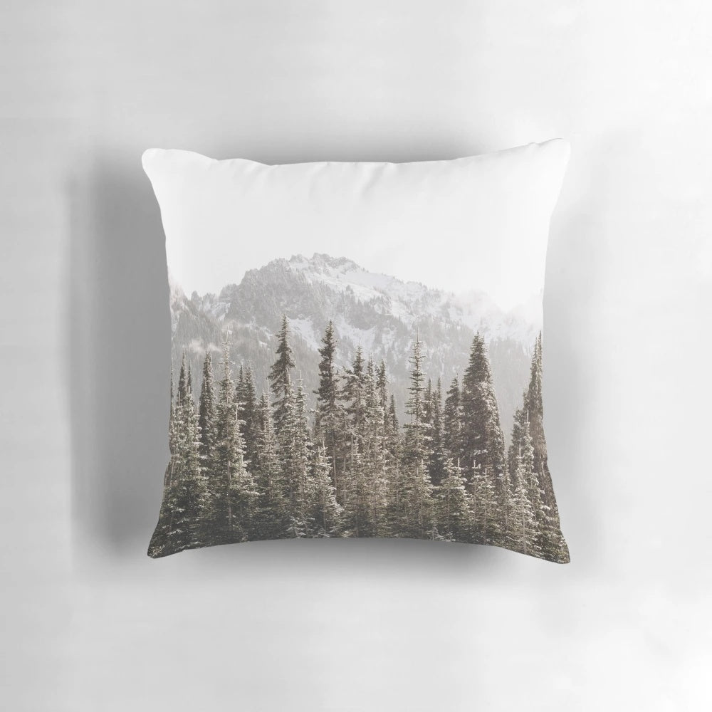 Soft and plush mountain forest pillow with snow-capped trees, fog, and a golden hour glow