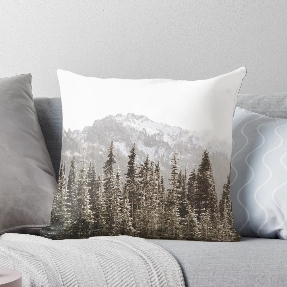 Soft and plush mountain forest pillow with snow-capped trees, fog, and a golden hour glow