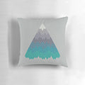 A decorative mountain-themed pillow featuring a minimalist geometric pattern in shades of blue and white.
