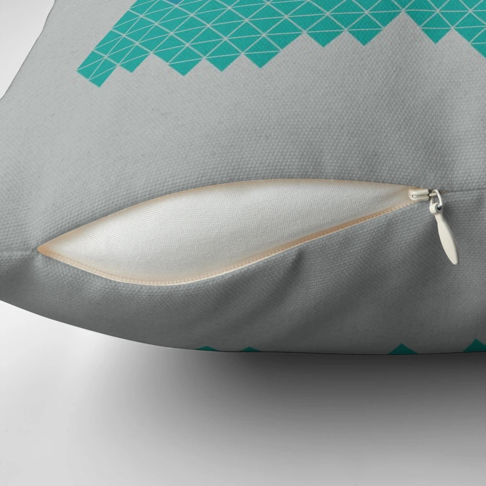 A decorative mountain-themed pillow featuring a minimalist geometric pattern in shades of blue and white.