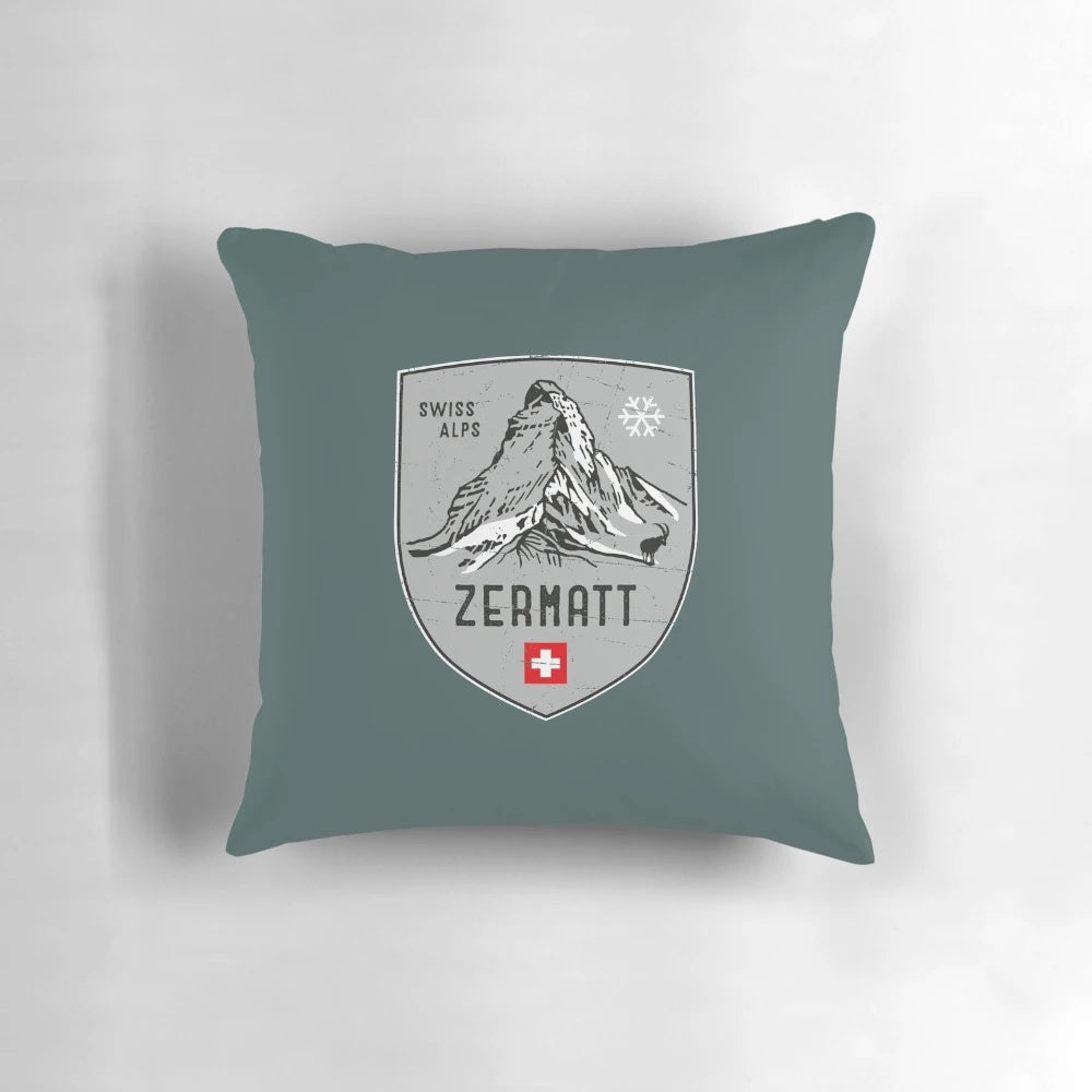 Decorative throw pillow featuring an emblem design inspired by the scenic Swiss Alps mountains