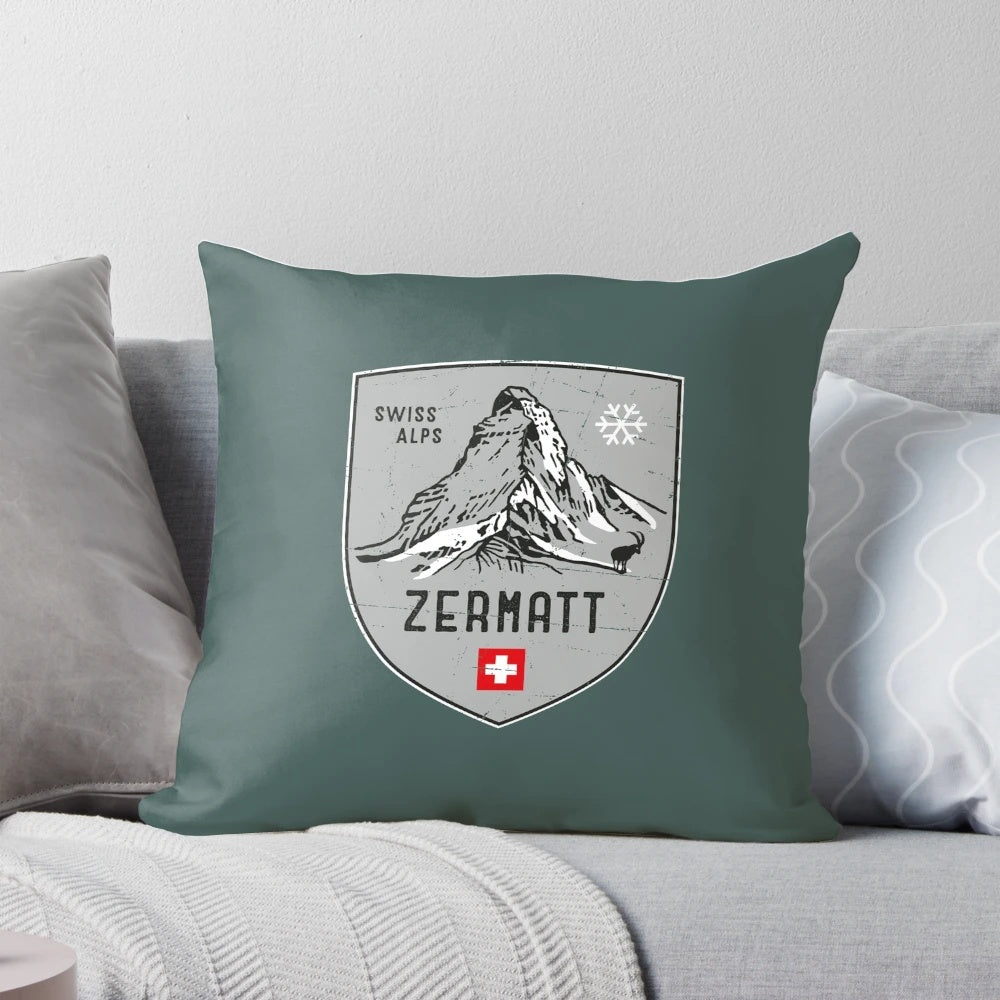 Decorative throw pillow featuring an emblem design inspired by the scenic Swiss Alps mountains
