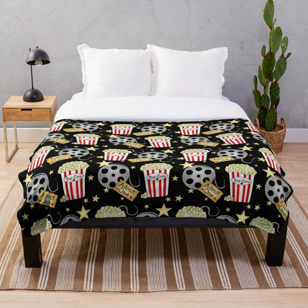 Plush blanket with popcorn design, perfect for movie nights