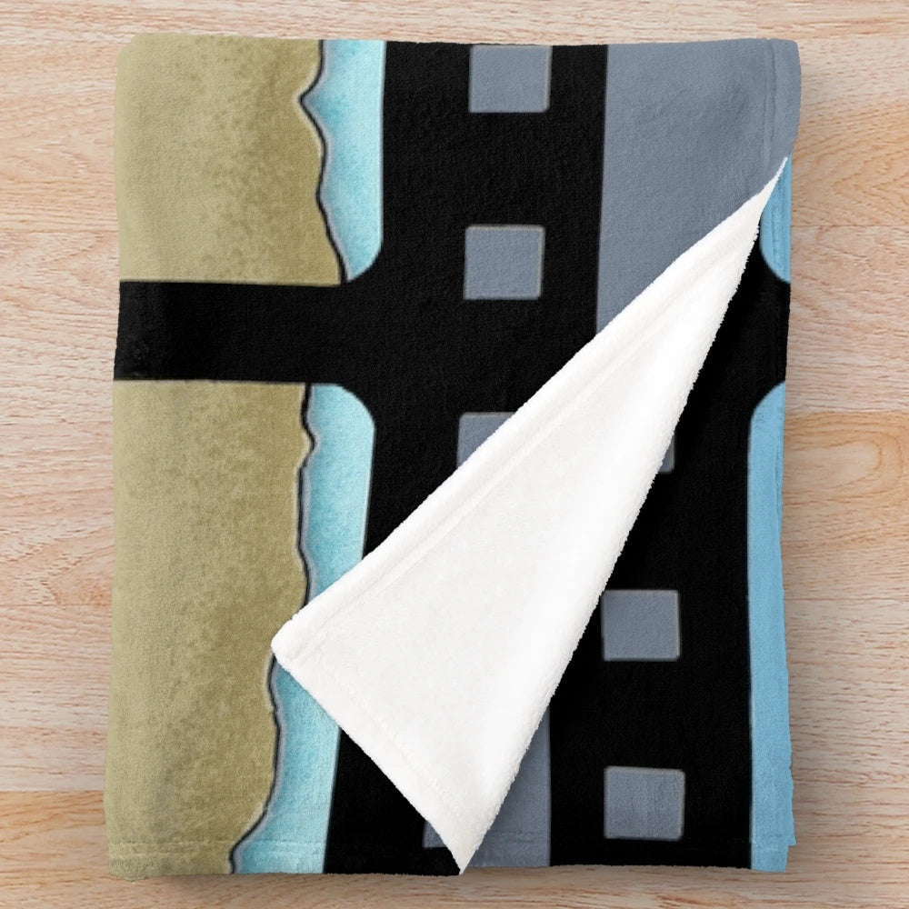 Cozy movie-themed plush blanket featuring digital artwork of houses, sun, beach, and cinema