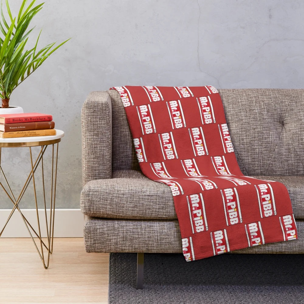 Mr. Pibb-themed plush blanket for cozy comfort