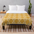 Mud cloth patterned plush blanket in earthy tones