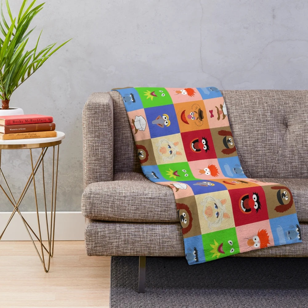 Muppets-themed plush blanket featuring characters like Kermit, Miss Piggy, and Fozzie Bear