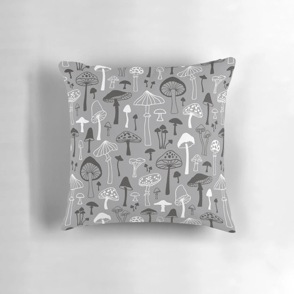 A decorative throw pillow featuring a hand-drawn mushroom silhouette in shades of gray against a white background, perfect for nature-inspired home decor.