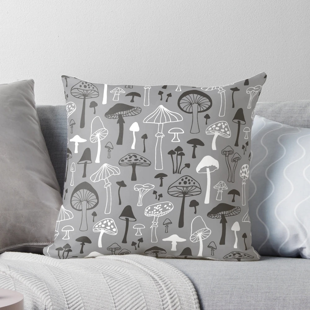A decorative throw pillow featuring a hand-drawn mushroom silhouette in shades of gray against a white background, perfect for nature-inspired home decor.