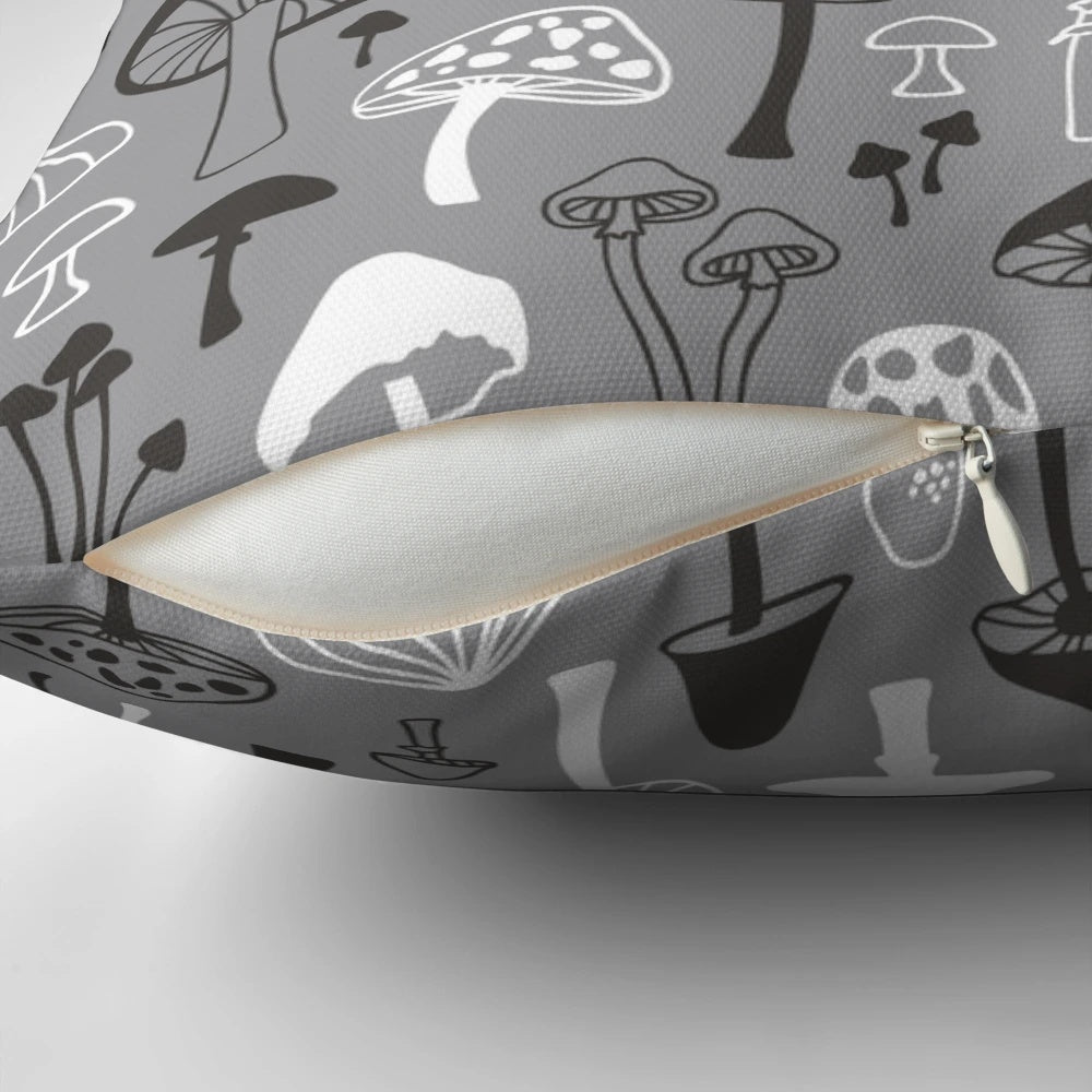 A decorative throw pillow featuring a hand-drawn mushroom silhouette in shades of gray against a white background, perfect for nature-inspired home decor.