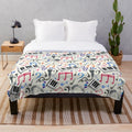A plush, patterned blanket featuring musical notes and symbols in various colors.