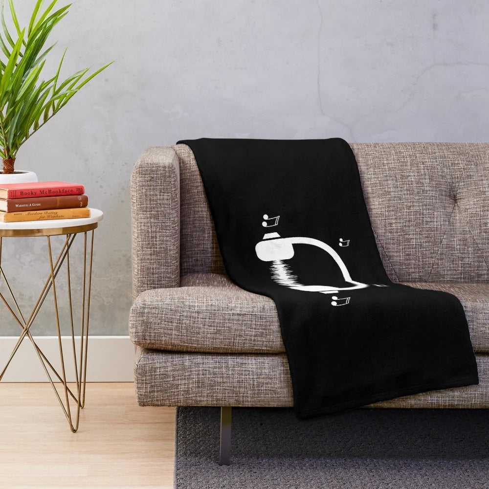 Cozy musical plush blanket featuring a variety of music-themed designs