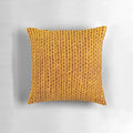 Closeup of a soft, fuzzy mustard yellow knit pillow for a cozy fall home.
