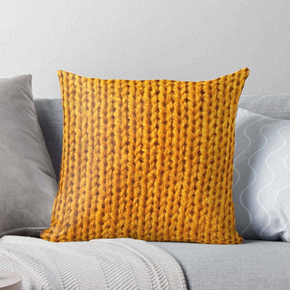 Closeup of a soft, fuzzy mustard yellow knit pillow for a cozy fall home.