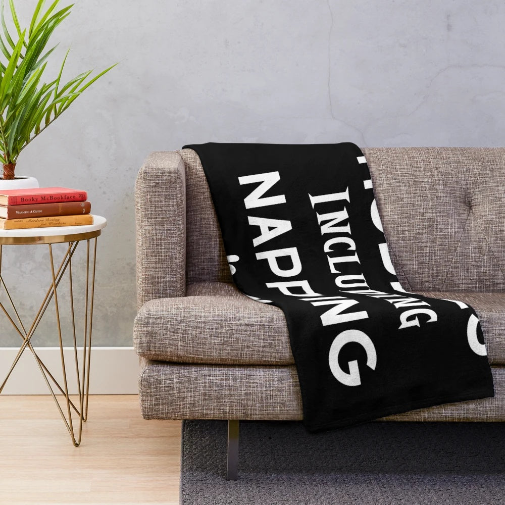 Plush blanket with "Hobbies Include Napping" design