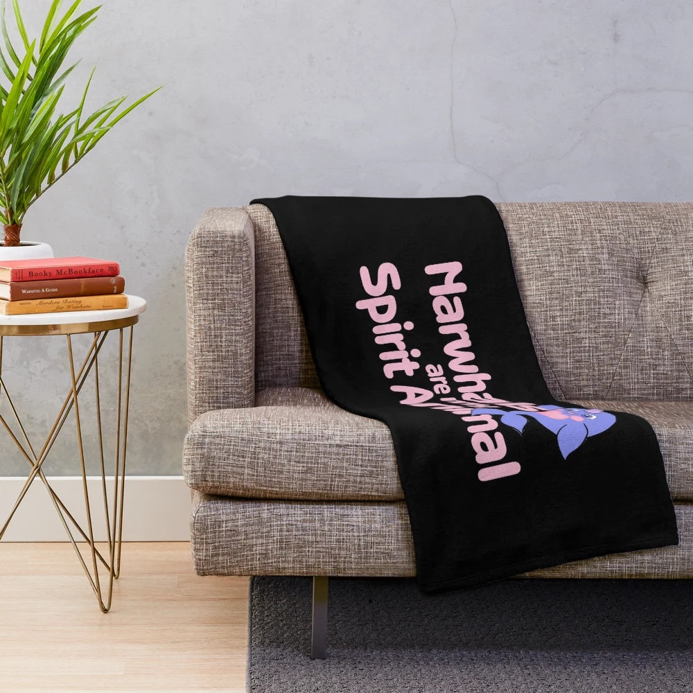 Narwhal plush blanket with a pink and purple design